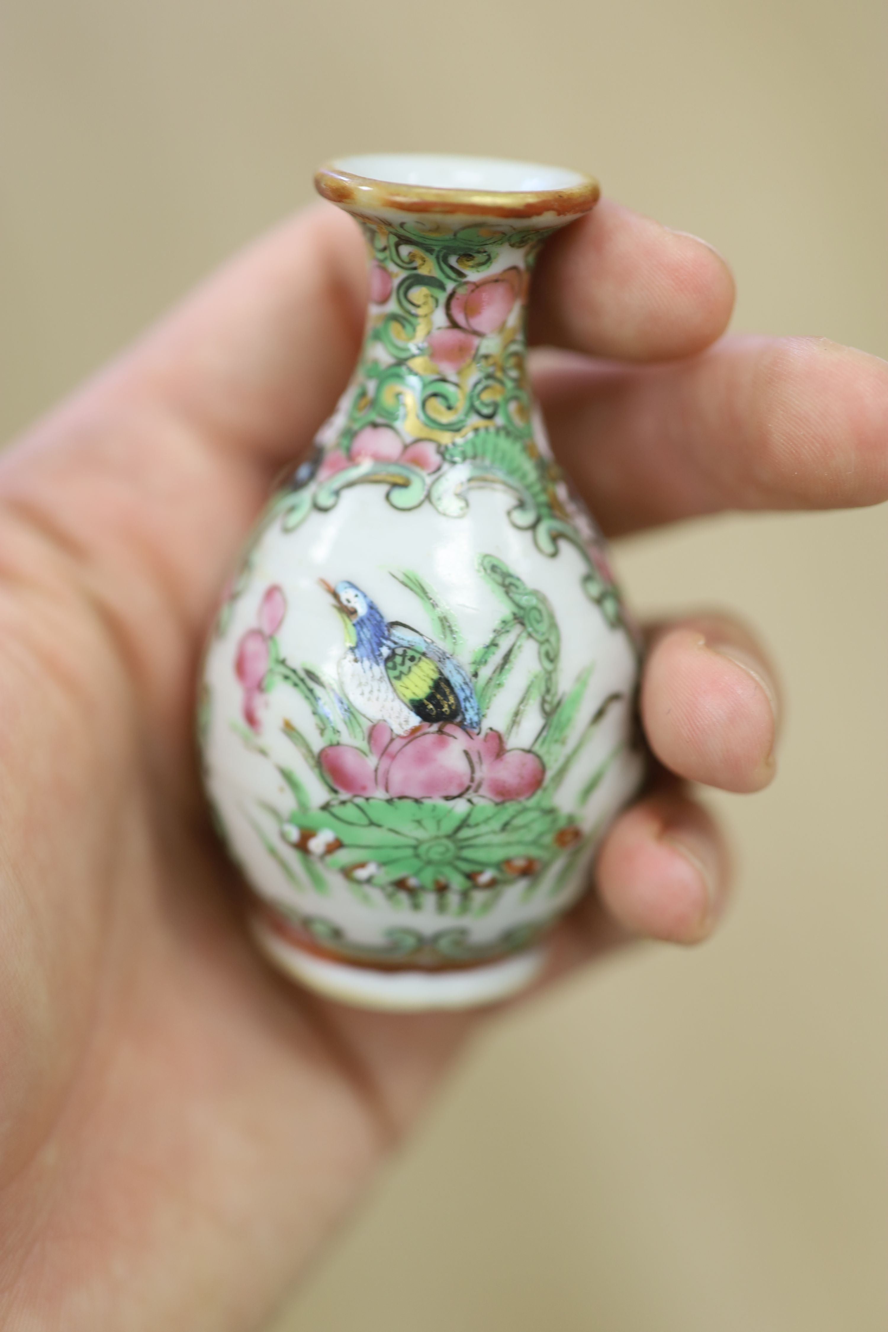 A Chinese famille rose box and cover, two vases, a sugar bowl and cover and a saucer, late 19th/early 20th century, tallest 19cm
